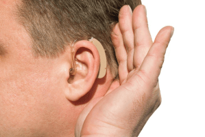 A deaf person with his hands over his ears