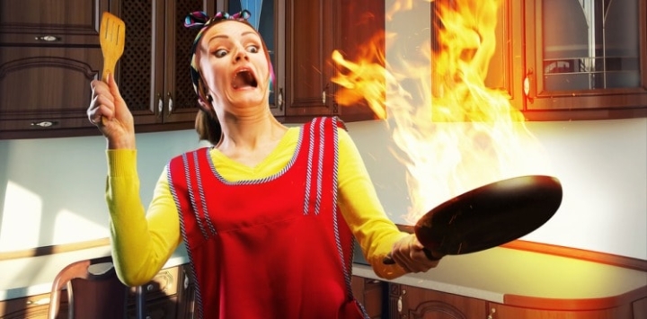 Cooking woman making a terrible cooking mistake