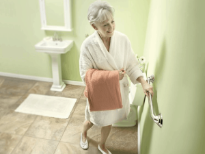 Senior standing up with a grab bar