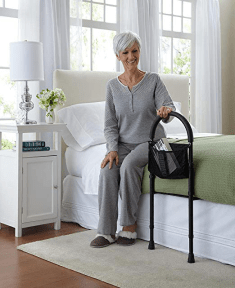 Woman using a bed assist bar